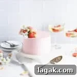 front view of champagne cake with glasses of champagne in the background
