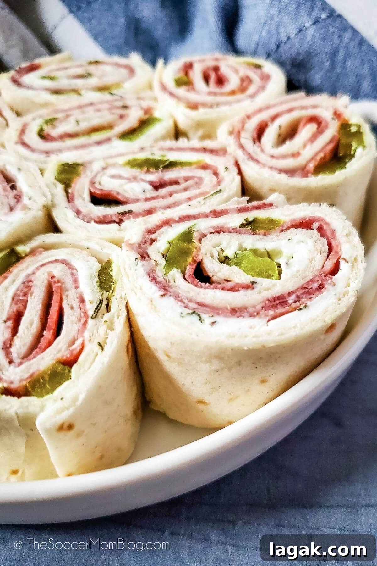 Dill Pickle Roll-Ups: Tangy Appetizer Recipe for Parties 2 close up of a plate filled with pickle pinwheels appetizer
