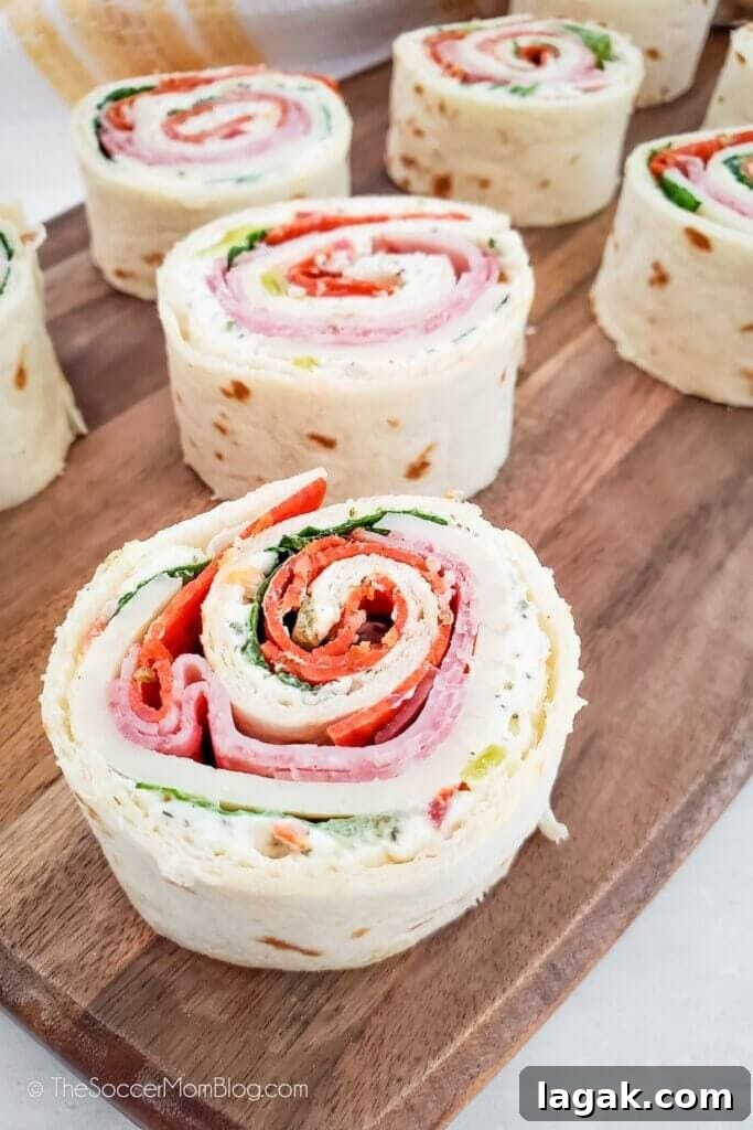 Dill Pickle Roll-Ups: Tangy Appetizer Recipe for Parties 10 Italian Pinwheels on a cutting board