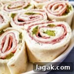 Dill Pickle Roll-Ups: Tangy Appetizer Recipe for Parties 8 Dill Pickle Pinwheels on a plate