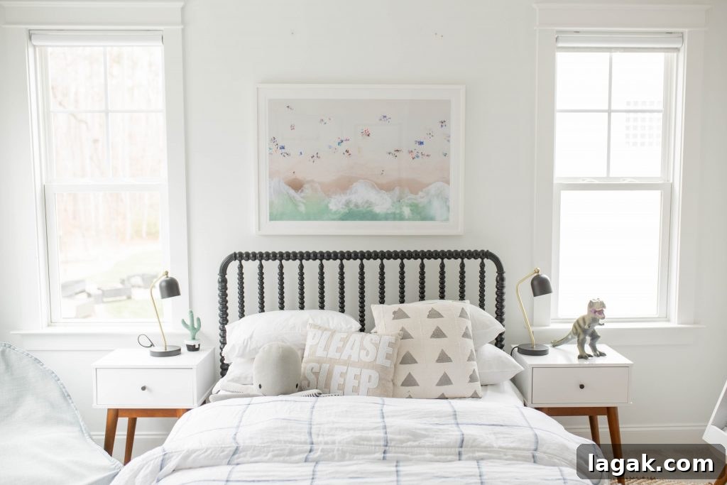 a child's bed with a Gray Malin print above it