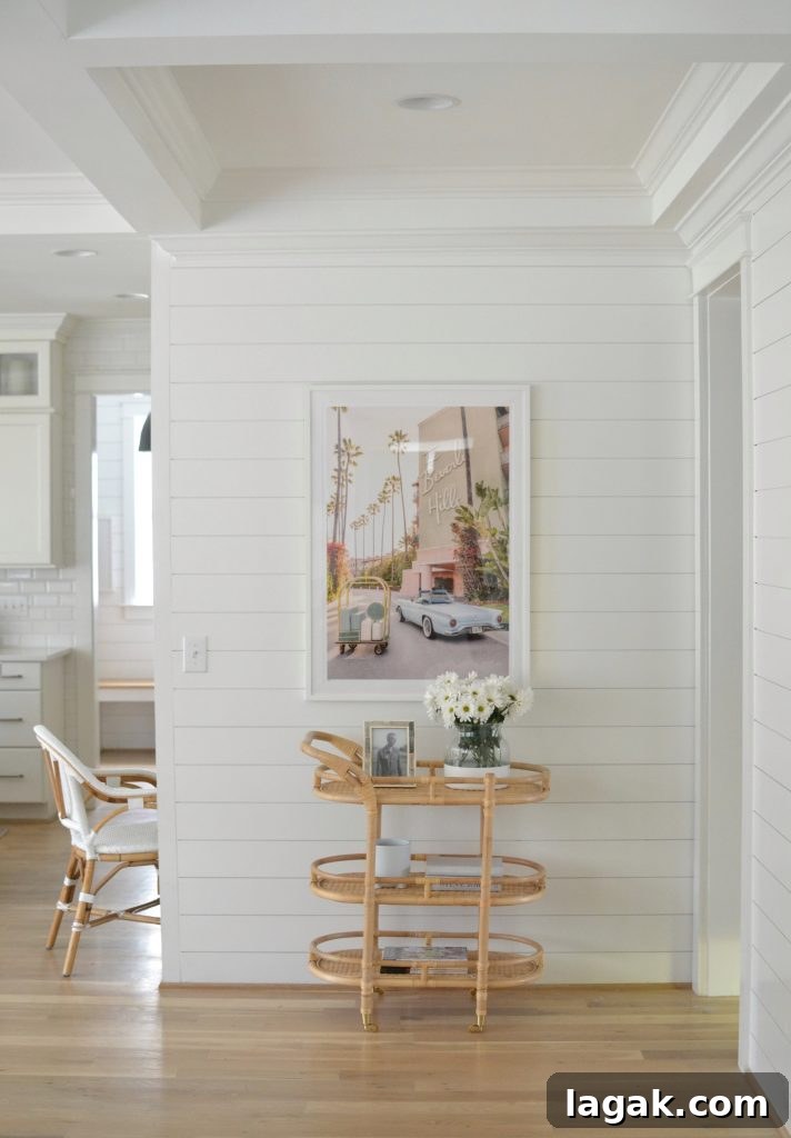 bar cart with Gray Malin prints above it