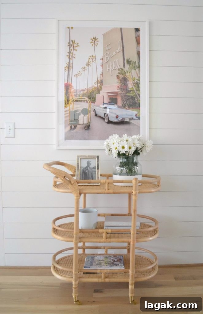 bar cart with styled flowers and Gray Malin prints