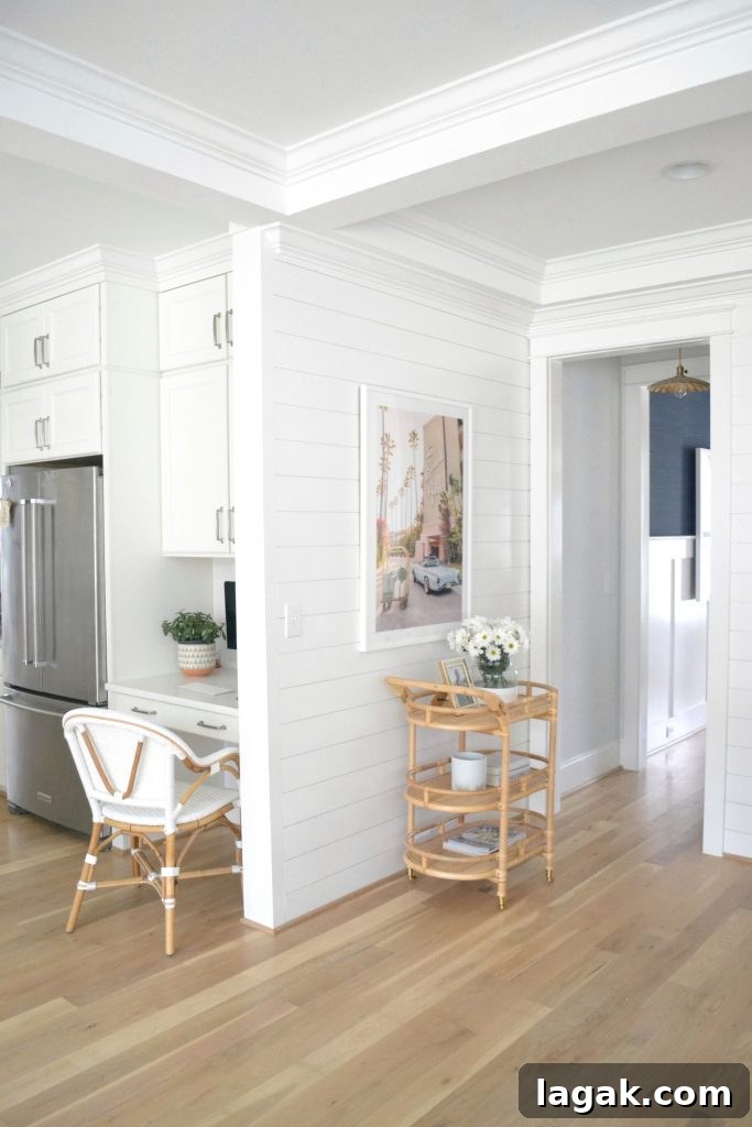 corner of a room with Gray Malin print and a bar cart