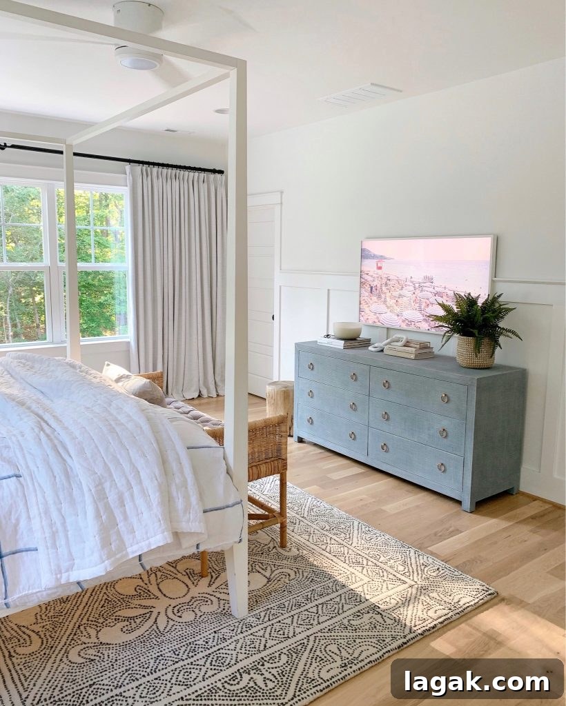 a bedroom with the Frame tv and Gray Malin prints