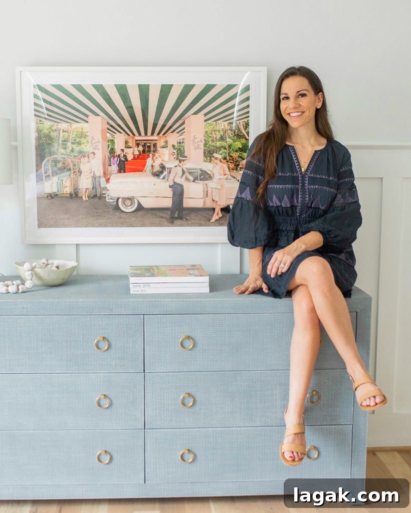 a girl sitting in front of Gray Malin prints