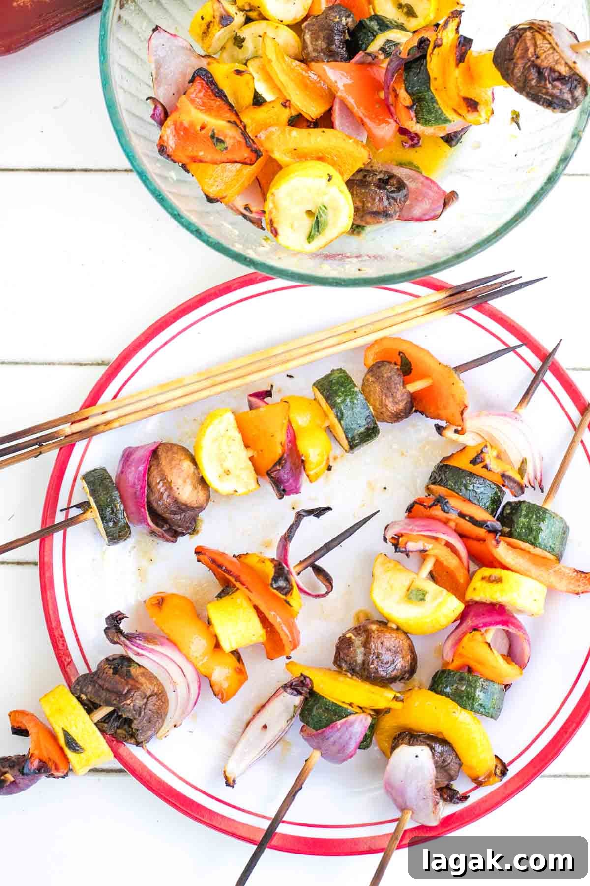Place with colorful vegetable kabobs and some taken off the skewers in a bowl.