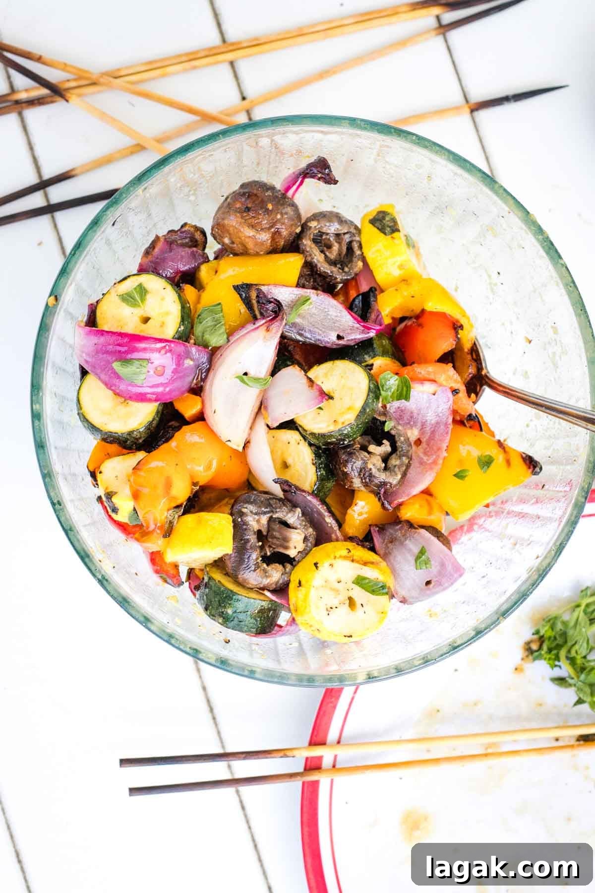 Grilled vegetables taken off their skewers and placed into a bowl.