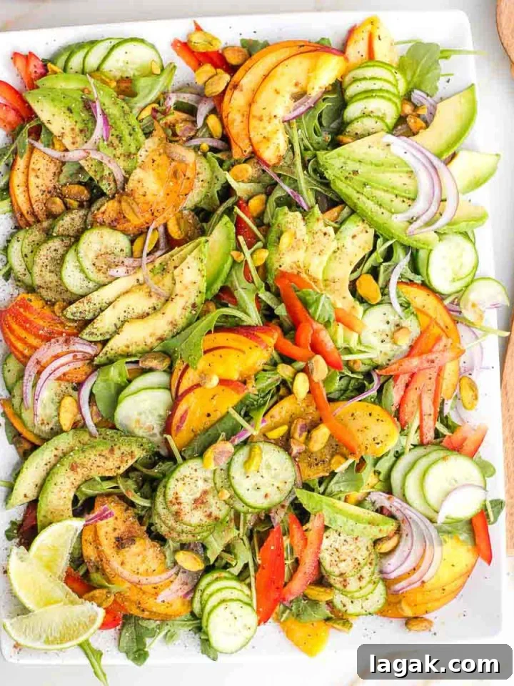 Arugula salad with sliced nectarines, avocado and cucumber.