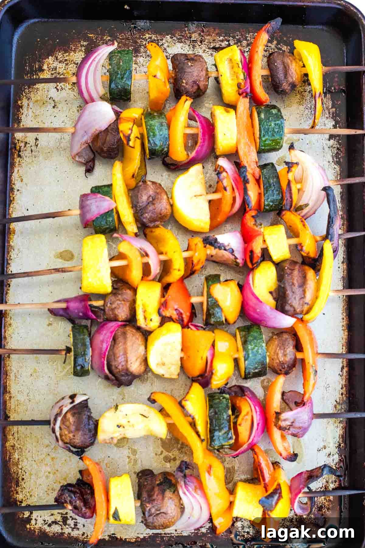Grilled vegetable skewers on a sheet pan.