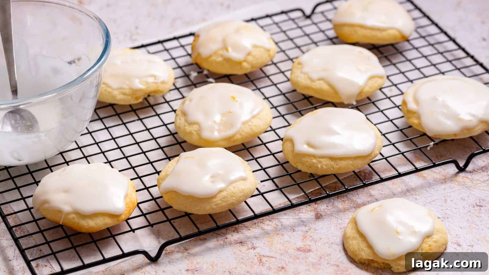 29 Party-Worthy Treats That Won’t Leave Leftovers 14 Lemon ricotta cookies on rack with icing bowl.