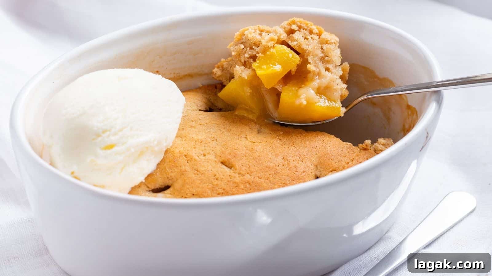 29 Party-Worthy Treats That Won’t Leave Leftovers 15 Peach cobbler with ice cream and peaches.