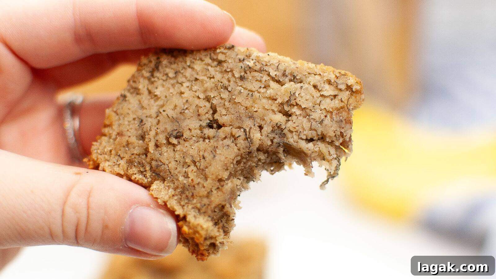 29 Party-Worthy Treats That Won’t Leave Leftovers 16 A hand holding a partially eaten slice of banana bread.