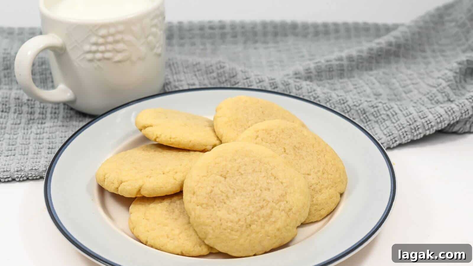 29 Party-Worthy Treats That Won’t Leave Leftovers 18 A plate of sugar cookies with a mug of milk and a gray cloth in the background.