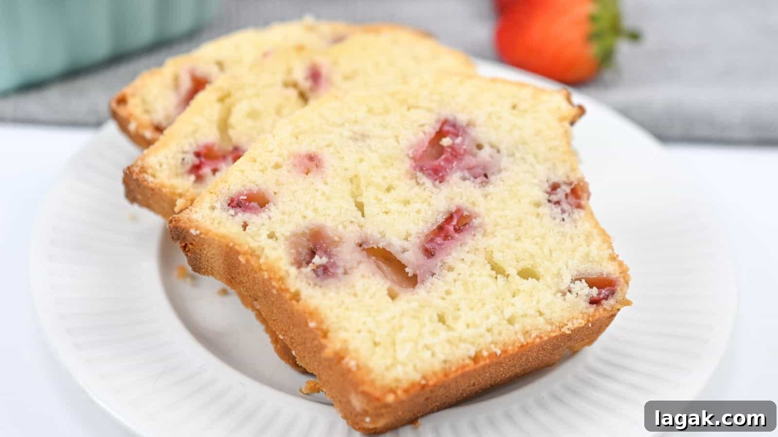 29 Party-Worthy Treats That Won’t Leave Leftovers 23 Slices of strawberry pound cake on a white plate, with visible chunks of strawberry and a golden-brown crust.