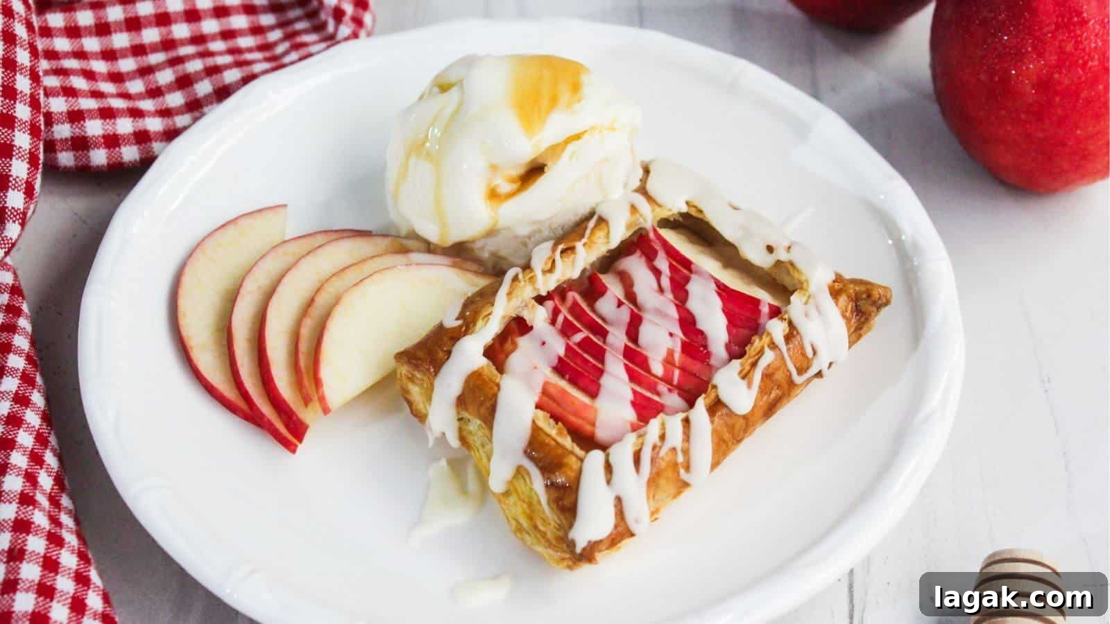 29 Party-Worthy Treats That Won’t Leave Leftovers 27 A dessert plate with apple slices, a pastry drizzled with icing, and a scoop of vanilla ice cream topped with syrup. A checkered cloth is nearby.