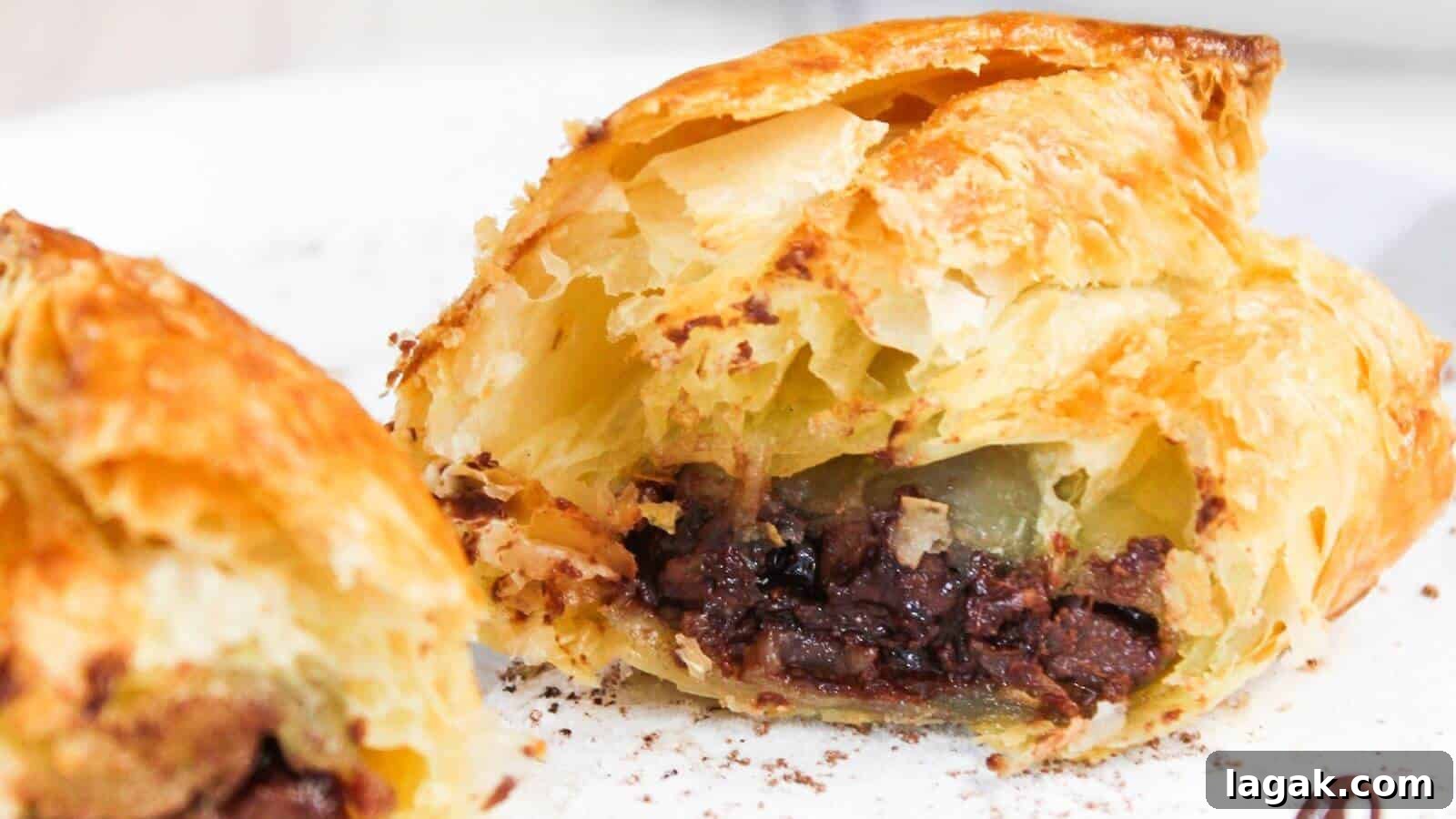 29 Party-Worthy Treats That Won’t Leave Leftovers 30 Close-up of a flaky pastry cut open to reveal a filling of chocolate, with a visible crispy golden crust.