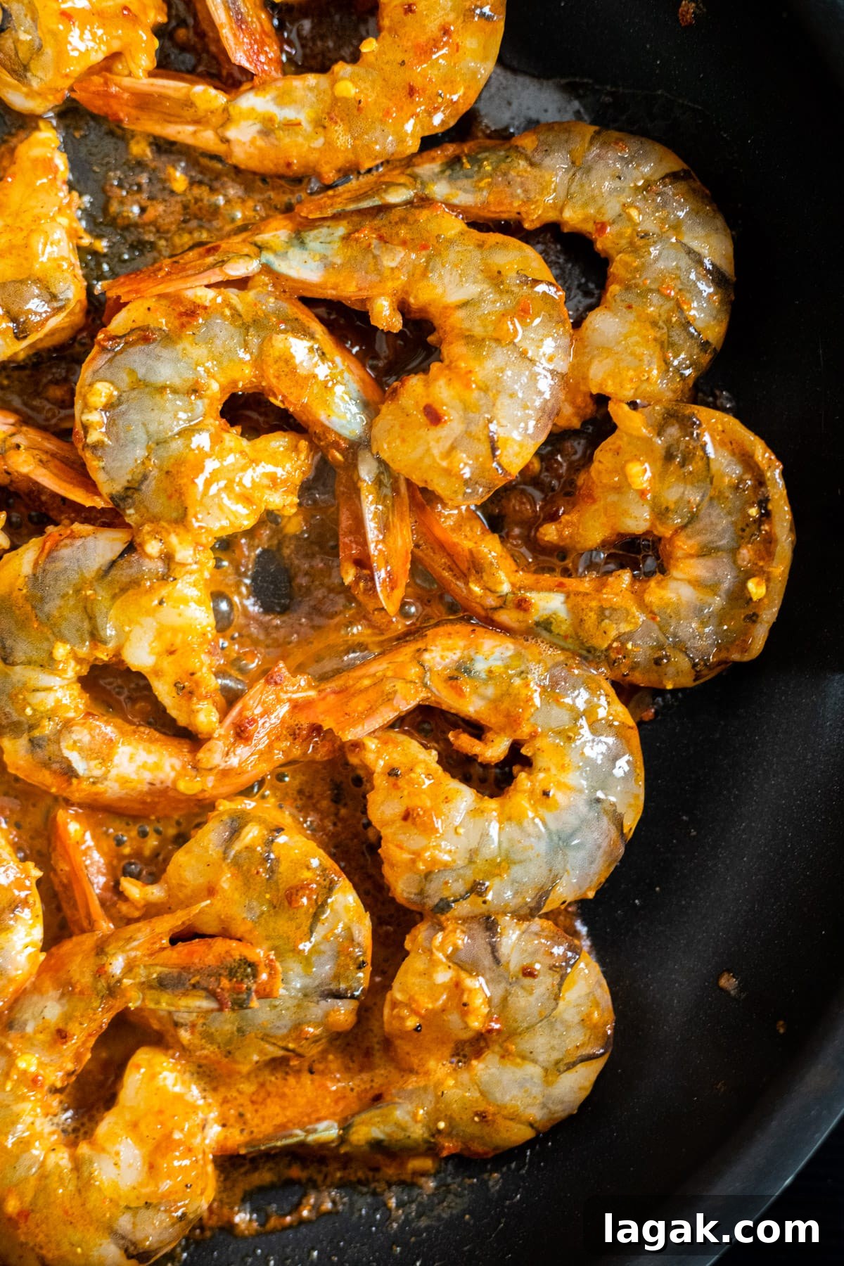 Zesty Chili-Lime Shrimp Skewers with Cilantro Lime Sauce 3 Chili seasoned shrimp cooking in a skillet.