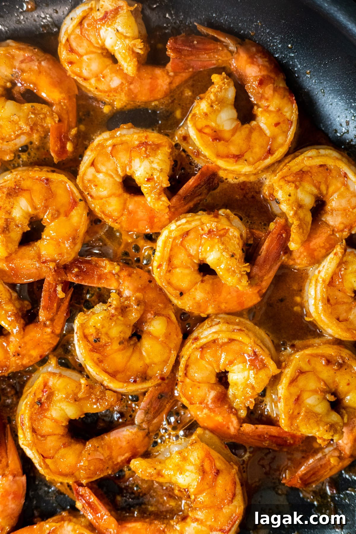 Zesty Chili-Lime Shrimp Skewers with Cilantro Lime Sauce 4 Cooked chili lime shrimp in a skillet.