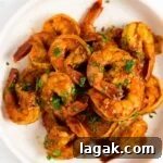 Zesty Chili-Lime Shrimp Skewers with Cilantro Lime Sauce 10 a top down view of a plate of chili lime shrimp