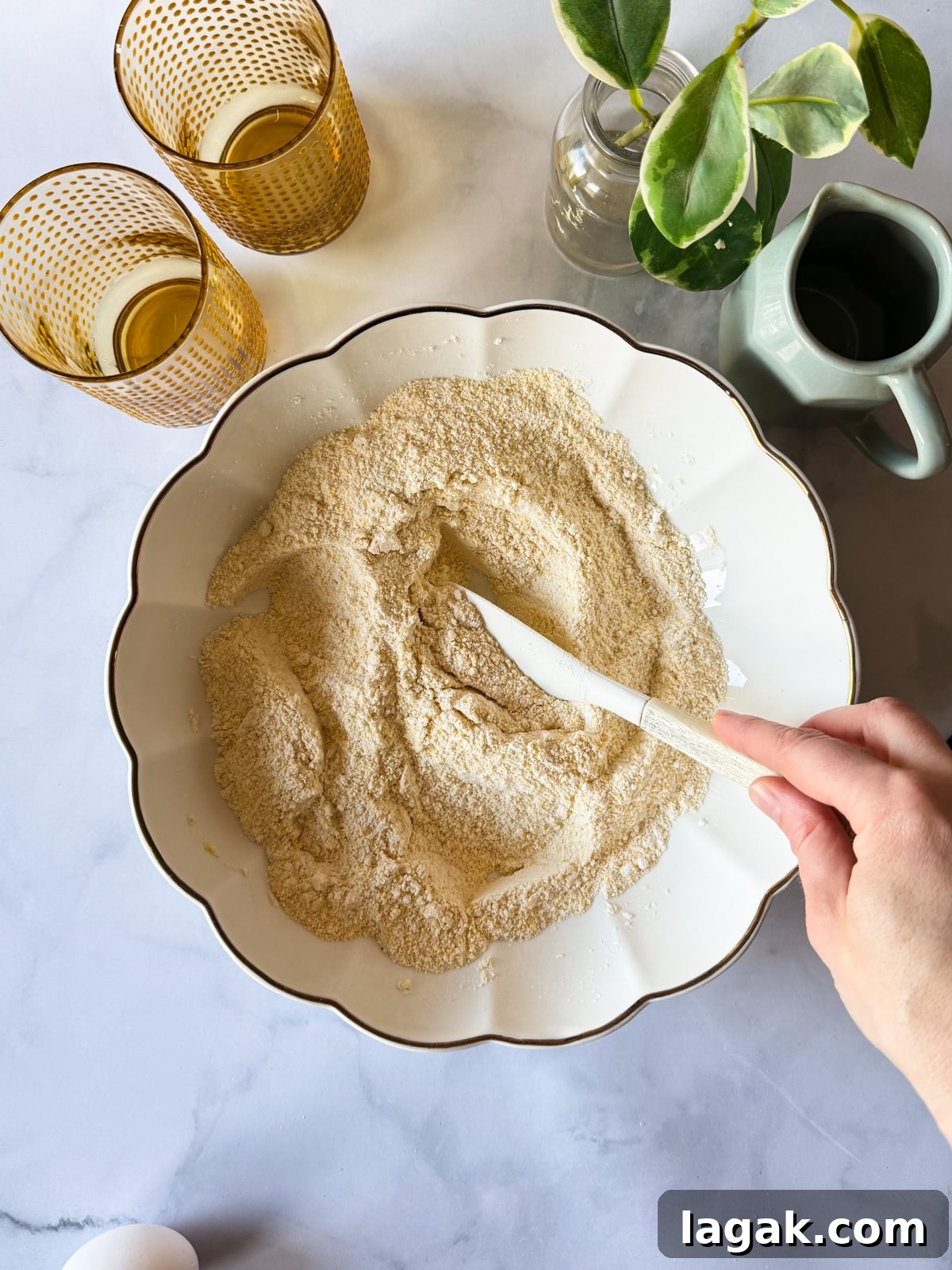 a bowl of cornmeal, gluten-free flour, sugar, baking powder, and baking soda mixed together in a bowl. 