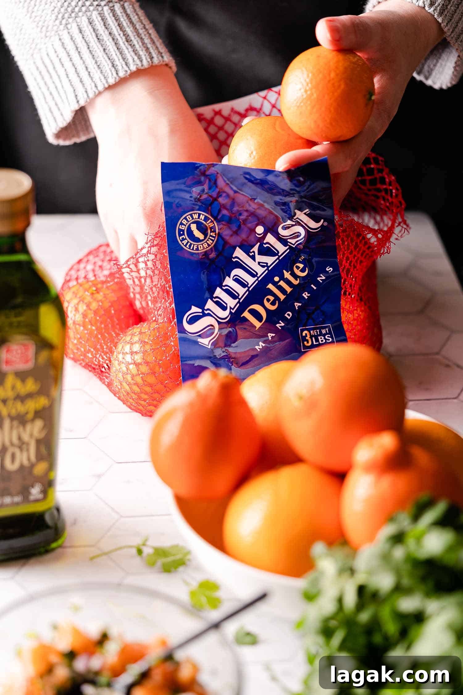 hands removing Mandarins from net bag