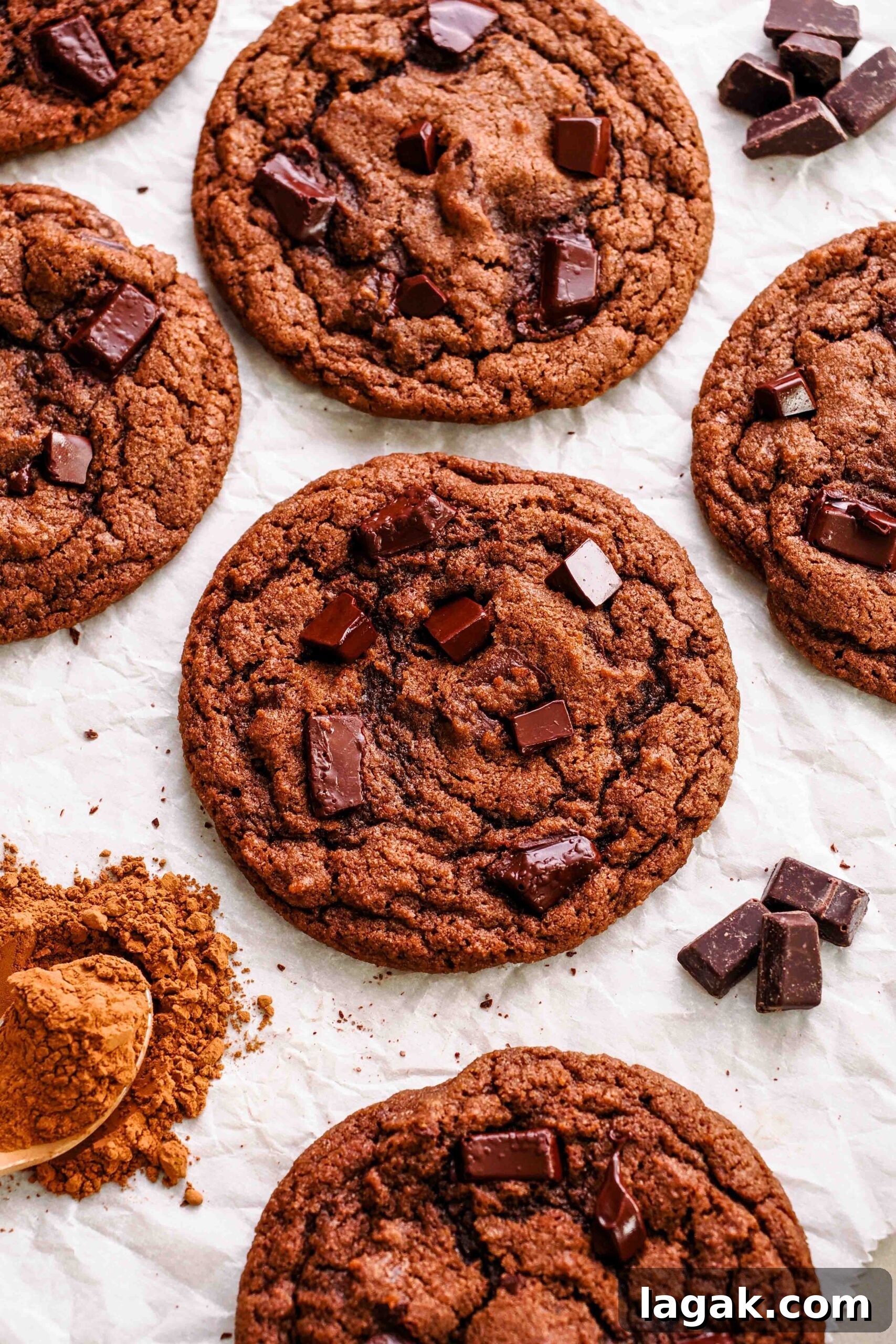 Ultimate Double Chocolate Chip Cookie Recipe for Rich, Gooey Cookies 2 Double chocolate chip cookies on crinkled parchment paper.