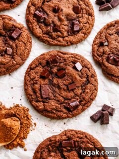 Ultimate Double Chocolate Chip Cookie Recipe for Rich, Gooey Cookies 18 Double chocolate chip cookies on crinkled parchment paper.