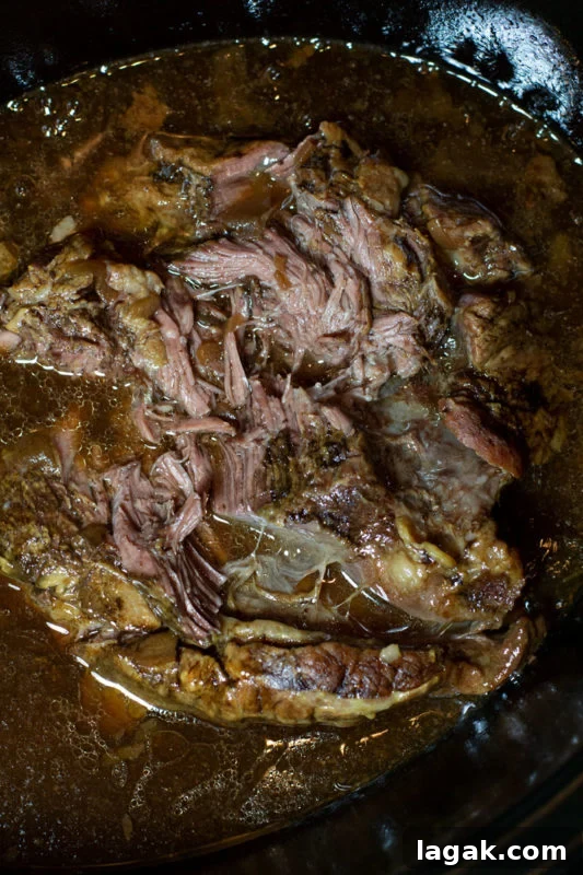 Crock-Pot French Dip Sandwich Recipe for Tender, Flavorful Beef 6 Shredded beef in a crockpot filled with juices and seasonings.