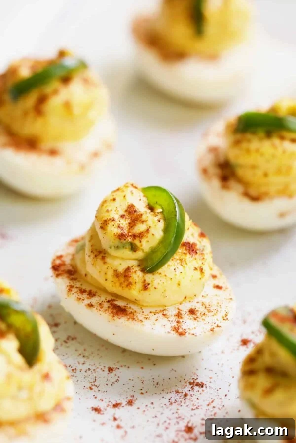 Close-up photo of Jalapeno Pimento Cheese Deviled Eggs garnished with jalapeno.