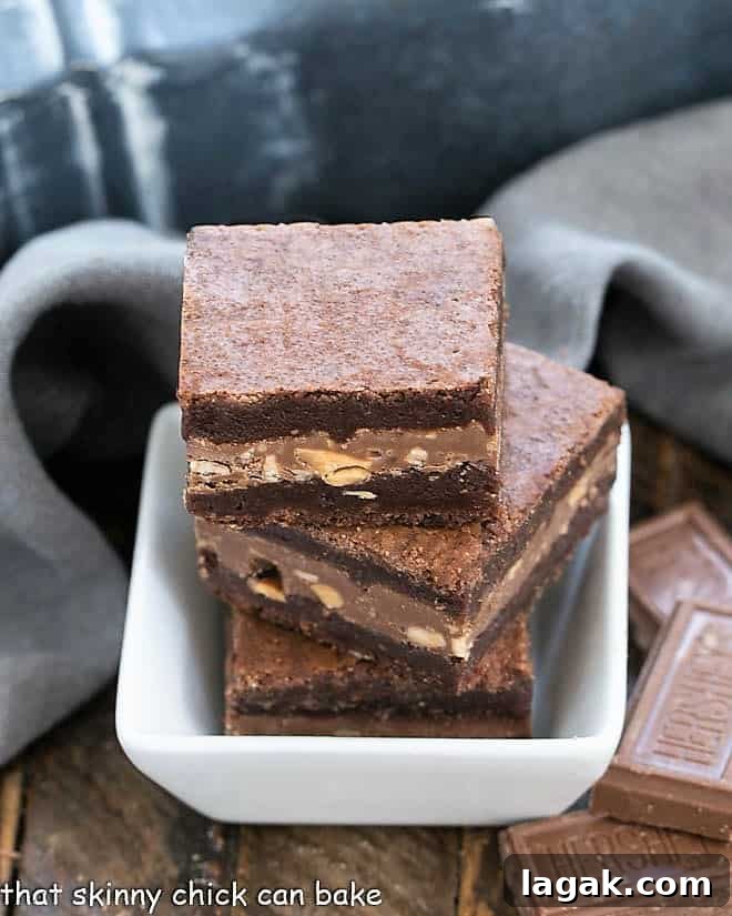 Symphony Toffee Brownies - rich, fudgy brownies with a milk chocolate, almond, toffee filling that pushes these over the top!!! 3 Symphony Toffee Brownies in a small square bowl.