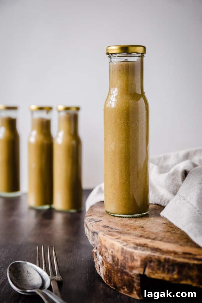 Homemade Green Tomato Ketchup Recipe: Tangy, Fresh & Preservative-Free 2 A bottle of Green tomato ketchup on a wooden board