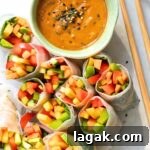 Cut veggie summer rolls and a bowl of peanut sauce