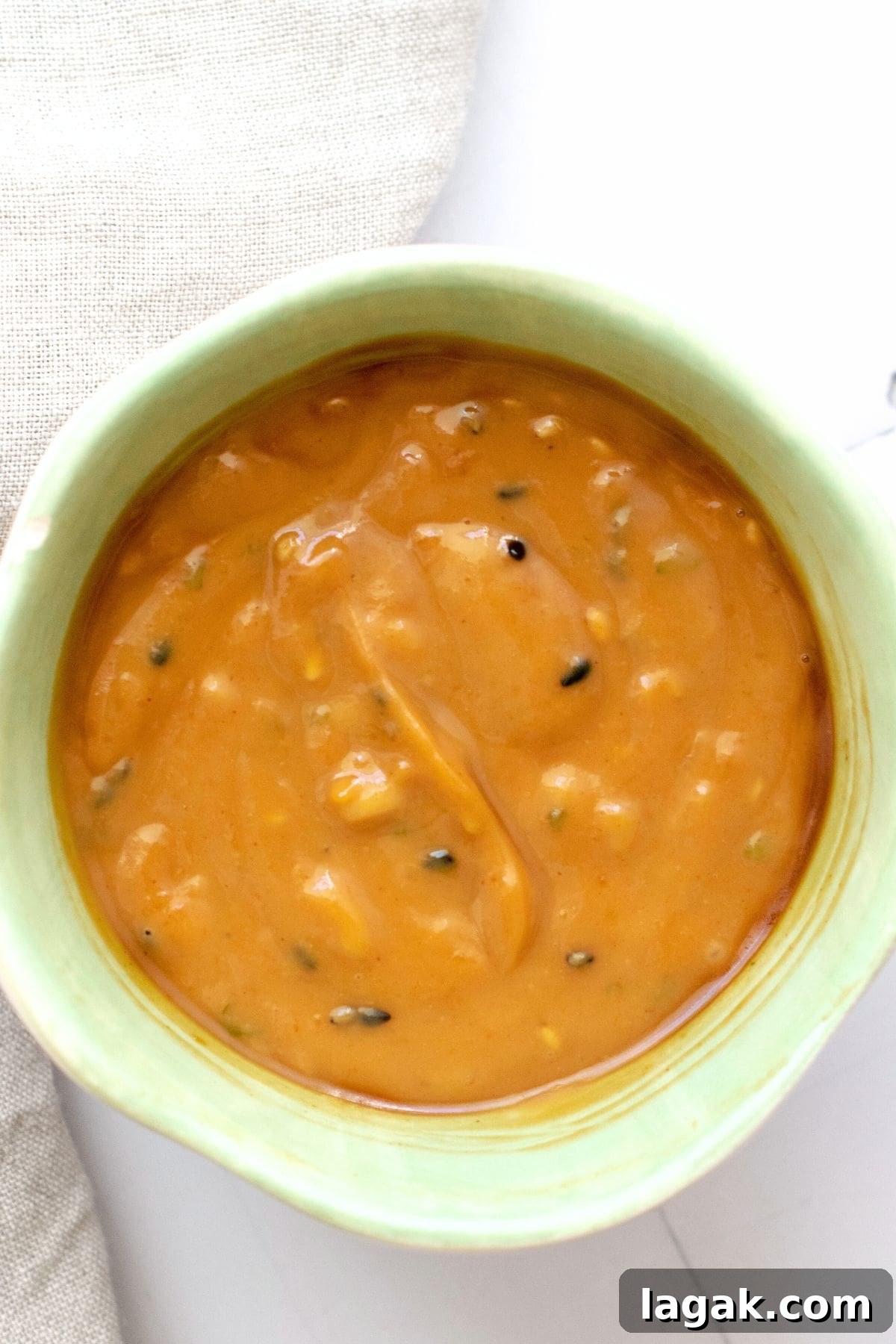 A bowl of peanut sauce topped with sesame seeds