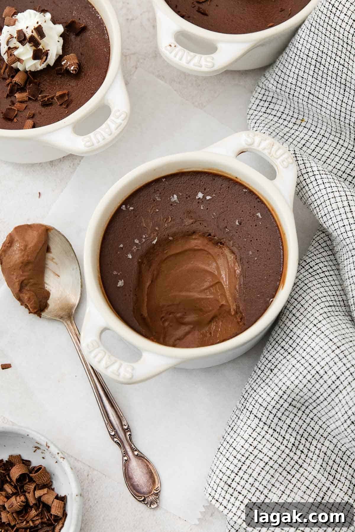 Silky Dark Chocolate Pot de Crème Recipe 3 a spoonful of pot de cream on a spoon next to the ramekin.