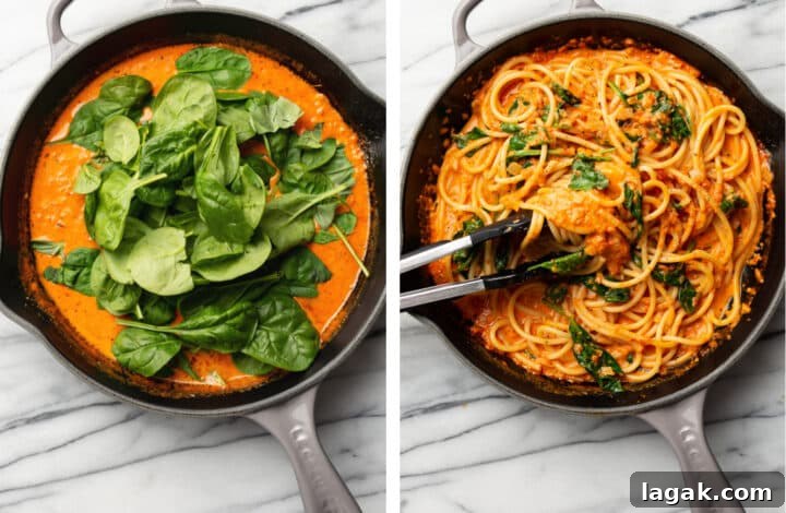 Creamy Roasted Red Pepper Pasta Recipe with Garlic and Basil 6 tossing pasta in a skillet with spinach and red pepper sauce