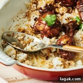 Spoon in a partially-served dish of Chicken Adobo.