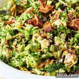 Bowl of Broccoli Salad topped with bacon and cheese.