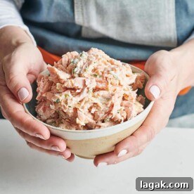 Woman holding a bowl of Salmon Spread.