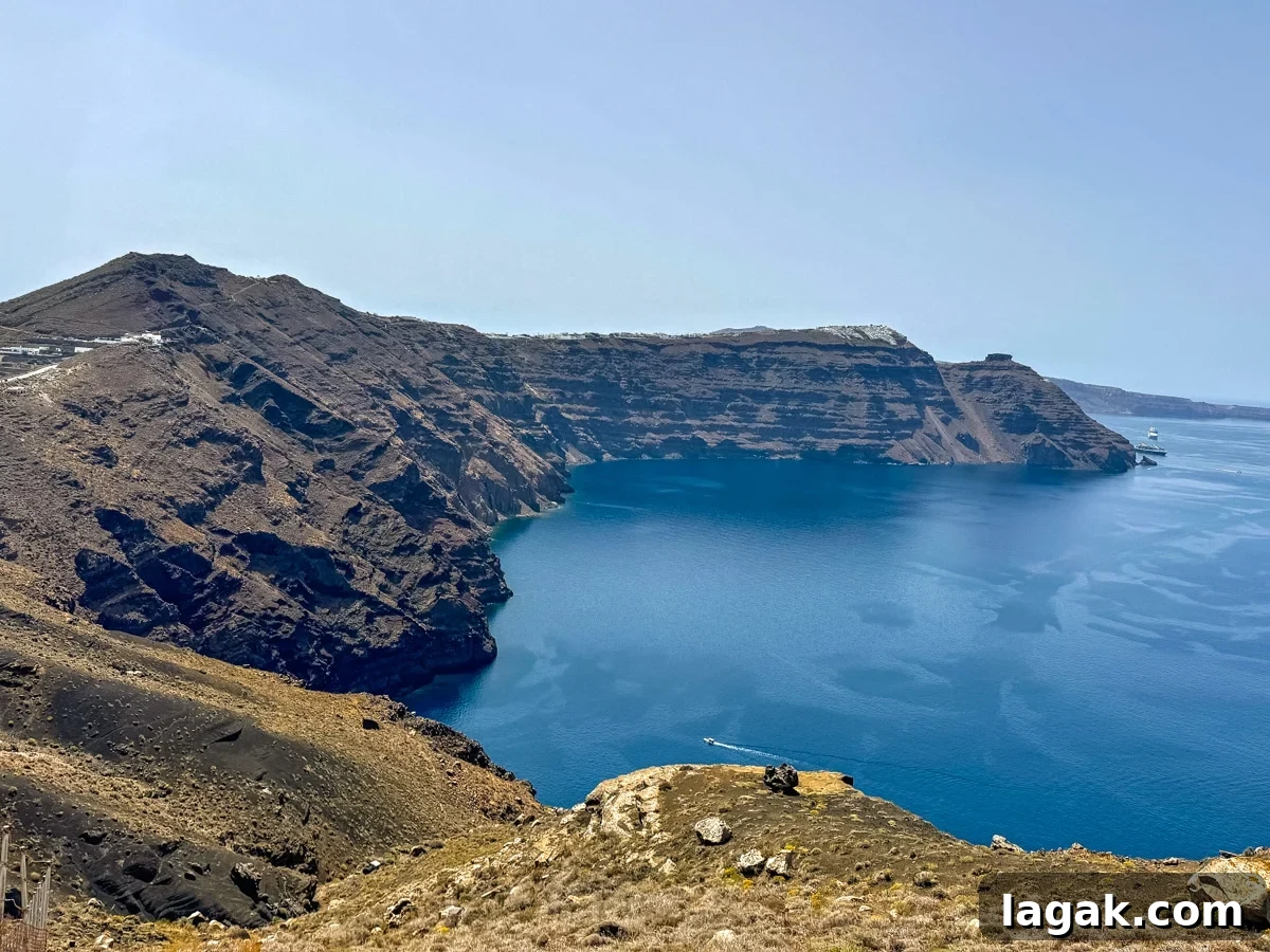 Avoid Saying This When Planning Your Next Trip: Travel Tips 5 A coastal view of a steep, rocky cliffside overlooking a deep blue sea on a sunny day, with a distant ship near the horizon.