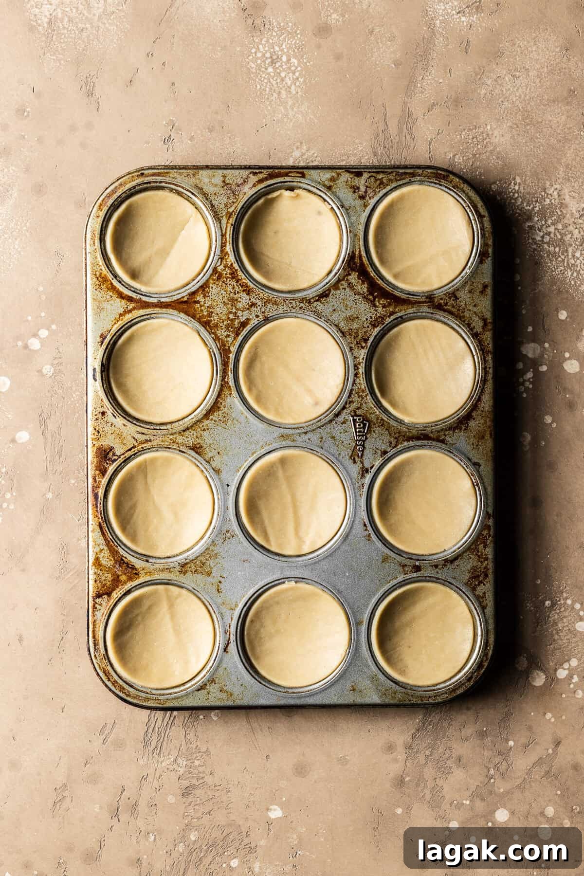 Homemade Nutella Biscuit Recipe: Crispy Chocolate Hazelnut Cookies 5 Unbaked dough circles for nutella biscuits in a muffin pan.