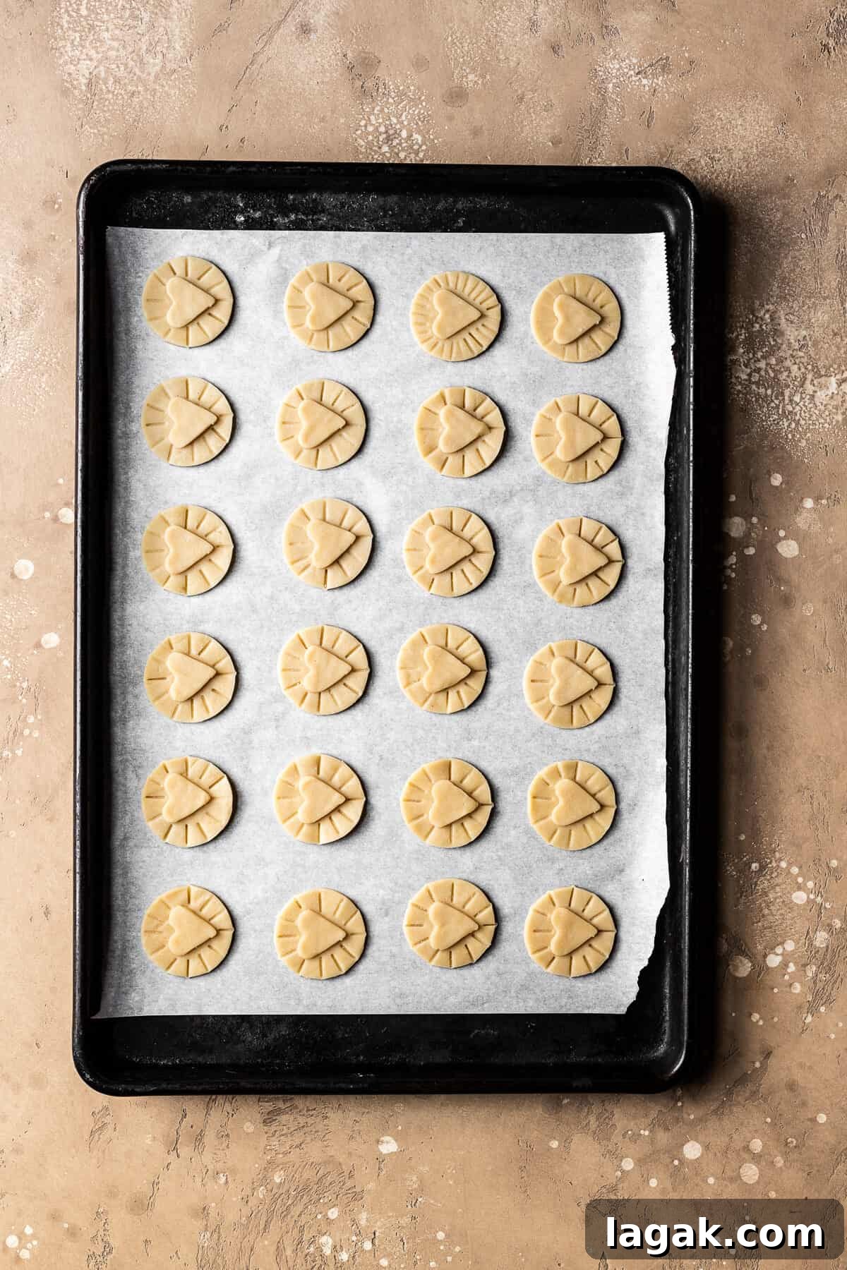 Homemade Nutella Biscuit Recipe: Crispy Chocolate Hazelnut Cookies 7 Unbaked dough circles with hearts on top for nutella biscuits.