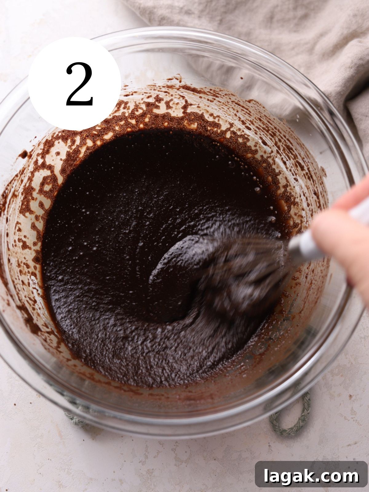Irresistible Brown Butter Brownies Recipe for Rich, Nutty Flavor 5 A glass bowl with cocoa powder and melted butter being whisked together.