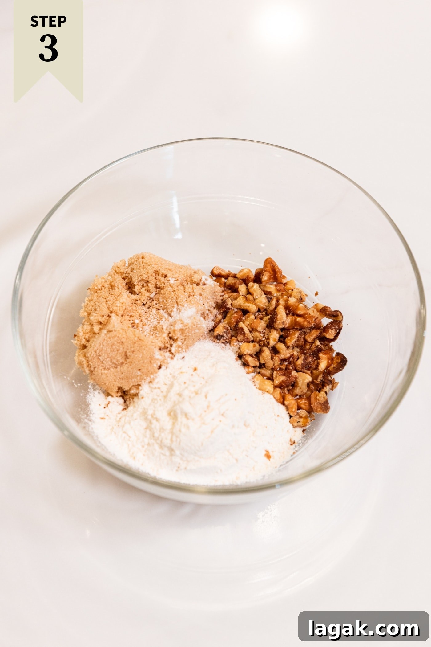 Warm Spiced Carrot Muffins with Cinnamon and Ginger 11 Glass bowl filled with ingredients needed for a streusel topping including brown sugar, white sugar, and nuts.