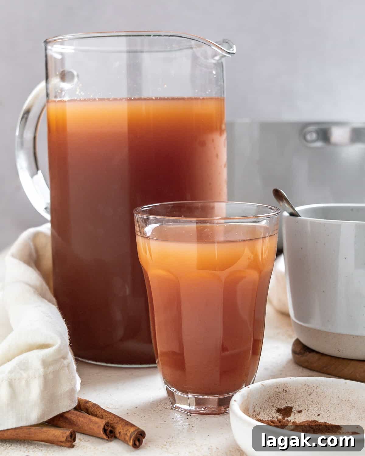 completed Mulled Apple Cider in two cups and a pitcher