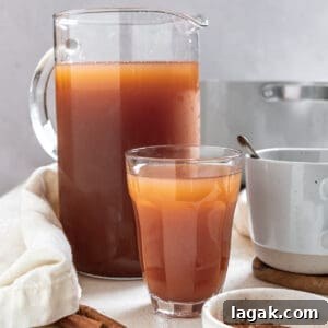 completed Mulled Apple Cider in two cups and a pitcher