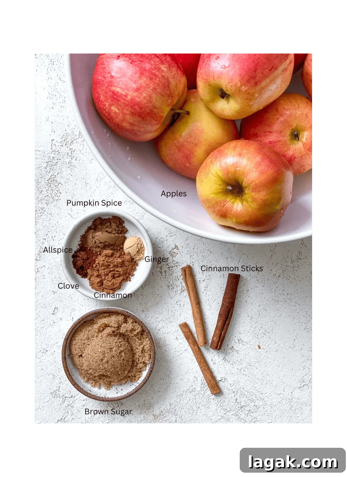 ingredients for Mulled Apple Cider against a white surface