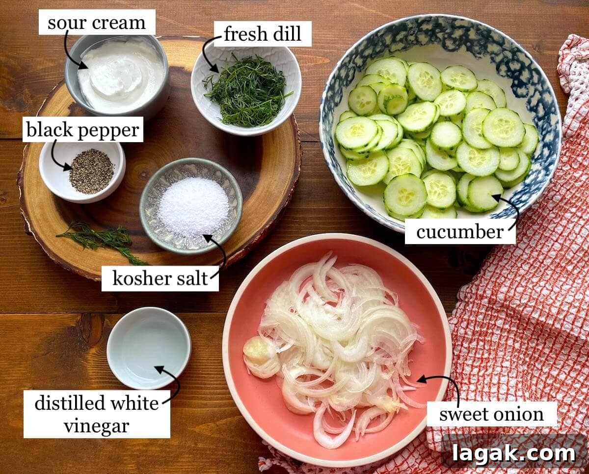 Creamy German Gurkensalat Recipe: Classic Cucumber Salad with Dill 3 The ingredients in creamy cucumber salad, laid out in bowls and labeled.