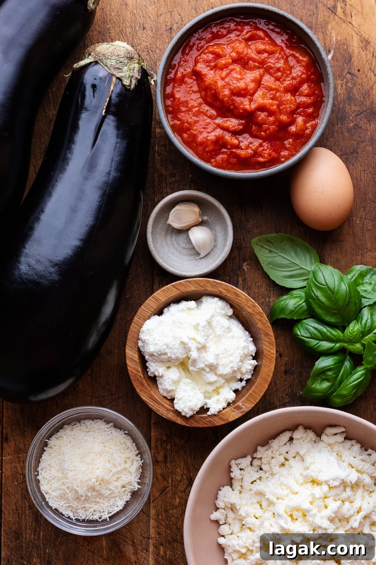 Classic Eggplant Rollatini Recipe — Simple Italian Comfort Food 3 Ingredients for eggplant rollatini arranged on a wooden board.