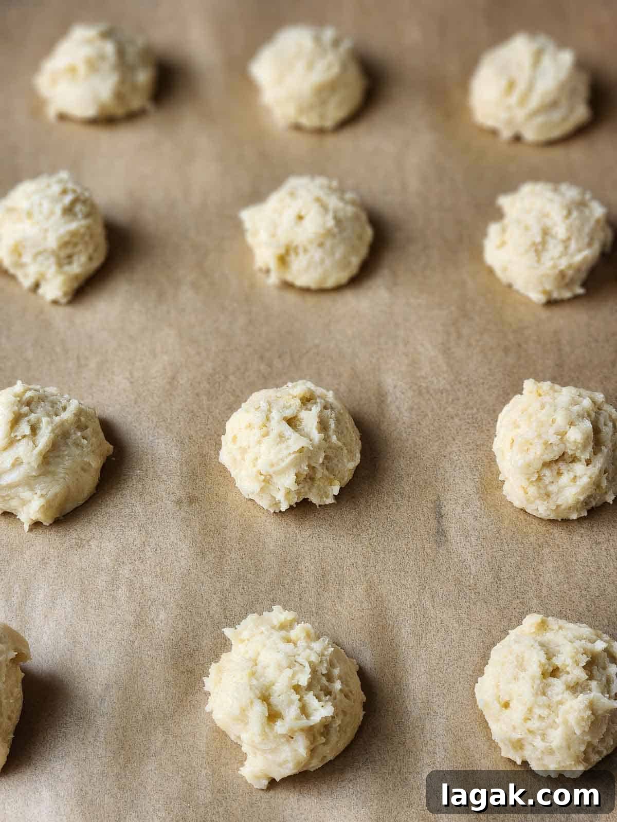 Italian Lemon Drop Cookies Recipe — Zesty Citrus Biscotti-Style Treat 7 Mounds of cookie batter on parchment paper.